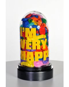 Erika Calesini, I'm Very Happy, Glass capsule with resinated balloons, yellow writing and rotating base, h28 cm